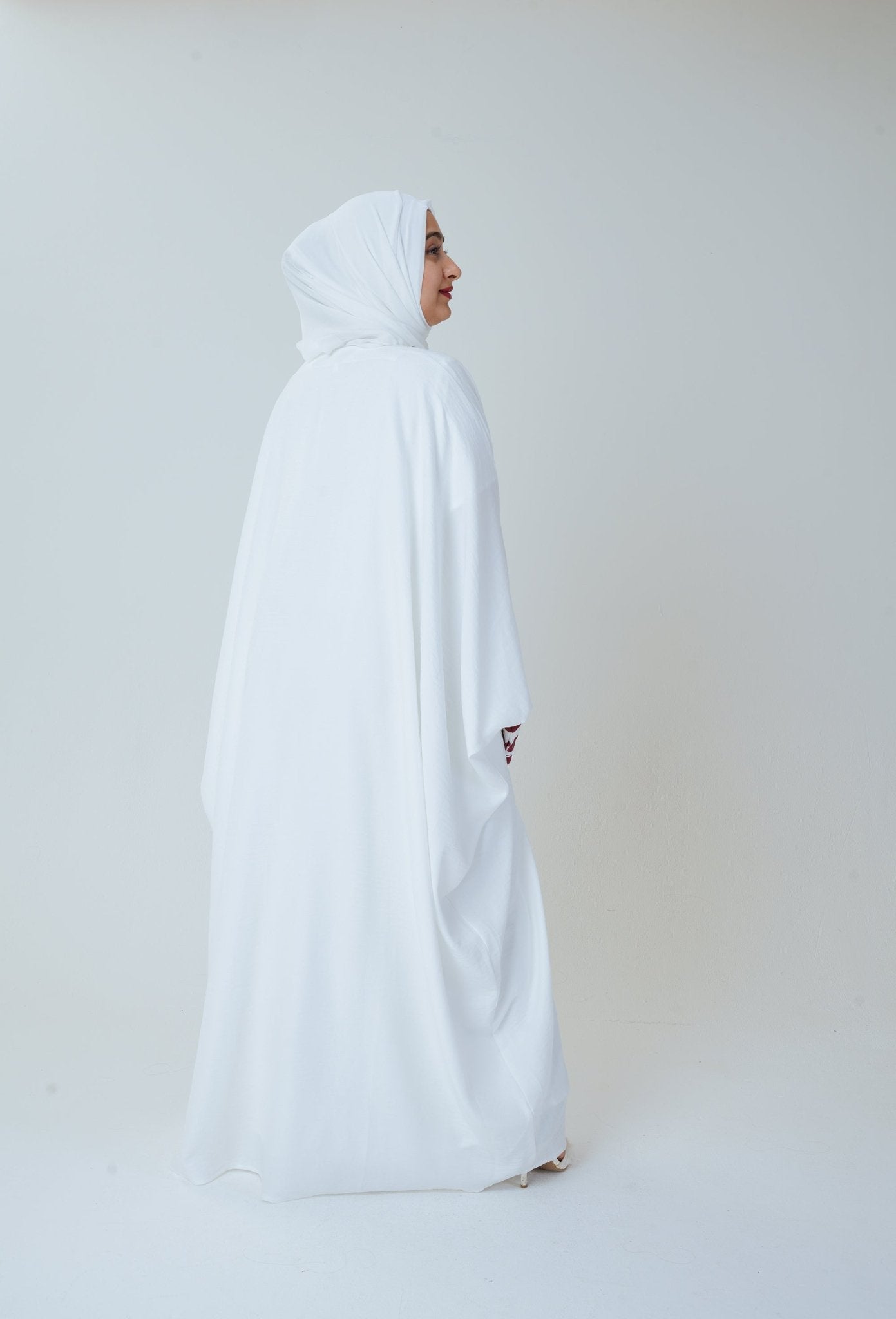 Women wearing embroidered abaya in white color , beautiful three piece white abaya. Modest Fashion by MODMOD
